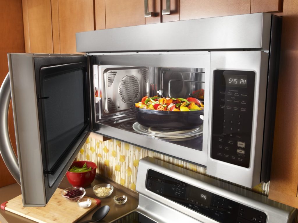 An image of a a built-in microwave with an open door.